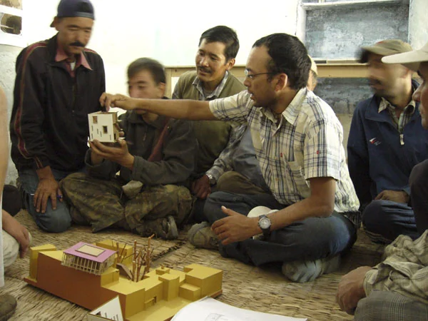 Local artisans discussing the design around the model